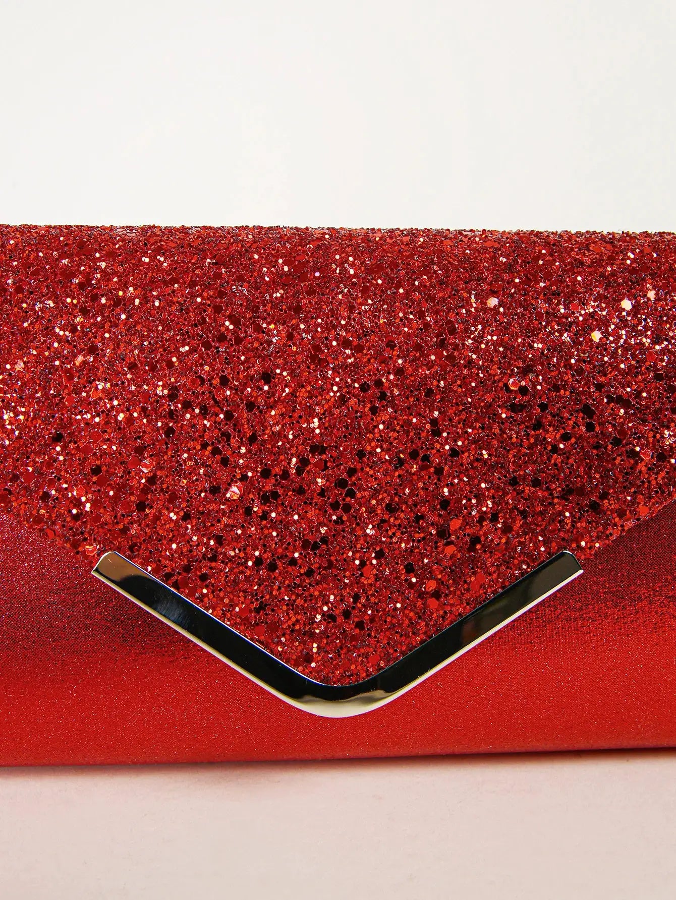 Sequin evening envelope clutch bag in red with a silver V-shaped clasp