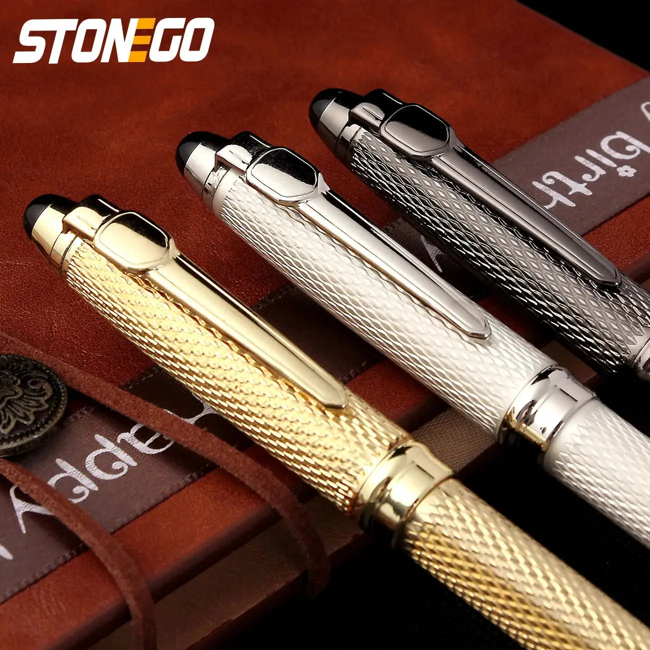 Ballpoint pens set by Stonego, 4 textured-barrel retractable pens in gold, silver, gray and black
