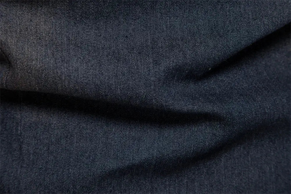 Denim shirt fabric close-up in dark blue with visible texture