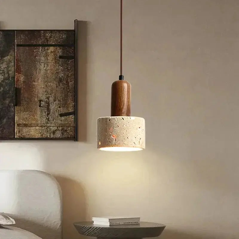 Travertine droplight pendant lamp with wooden top, above a small side table