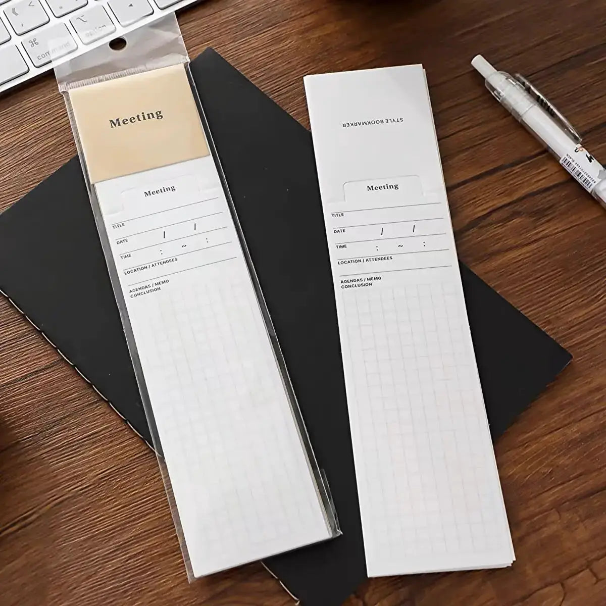 MINKYS bookmark-style memo pads, two white grid-paper notepads labeled Meeting, on wood desk, one in packaging