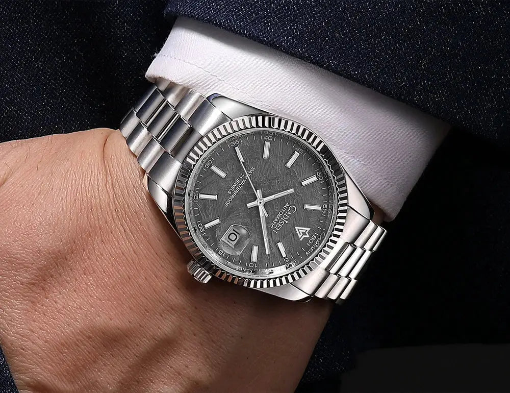 CADISEN men's automatic watch with fluted bezel, dark textured dial, date magnifier at 3, luminous markers