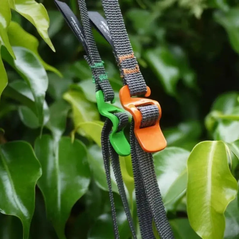 Simples Market luggage strap with quick-release dual green and orange buckles on black nylon