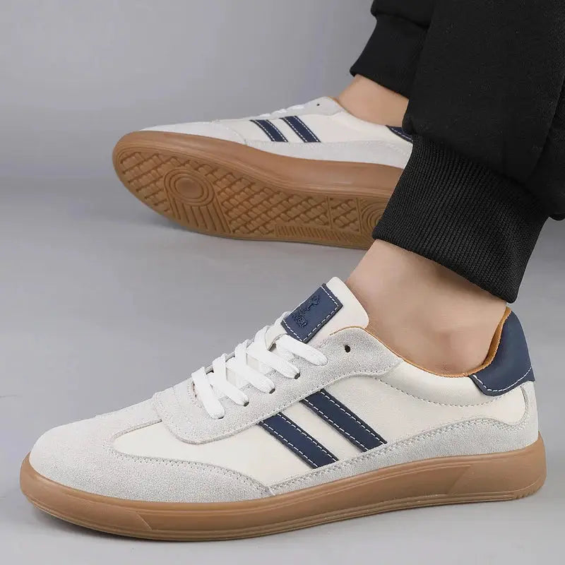 Men's leather sneakers with white upper, navy side stripes and tan gum sole