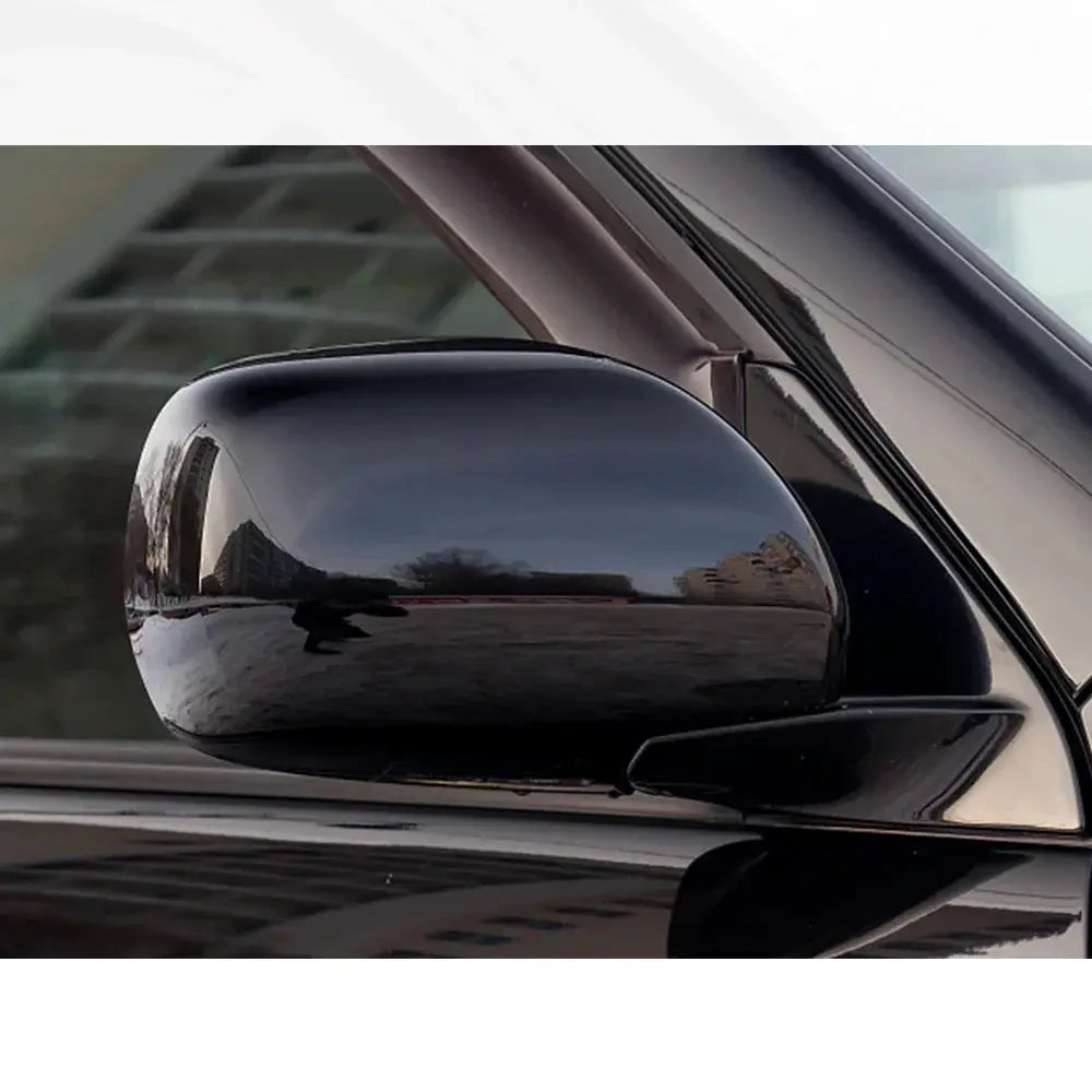 Glossy black car side mirror wrap on a sleek vehicle; self-adhesive vinyl film, 150x50 cm