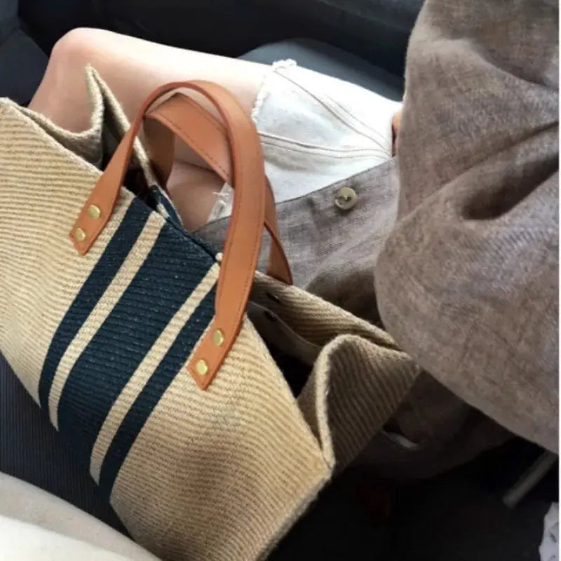 Canvas stripe bucket tote bag with top handles, natural canvas and navy stripes, tan leather accents, large capacity