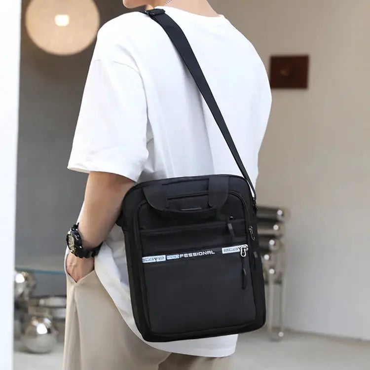 Men's crossbody bag by Simples Market; black nylon with adjustable strap and front zip pocket