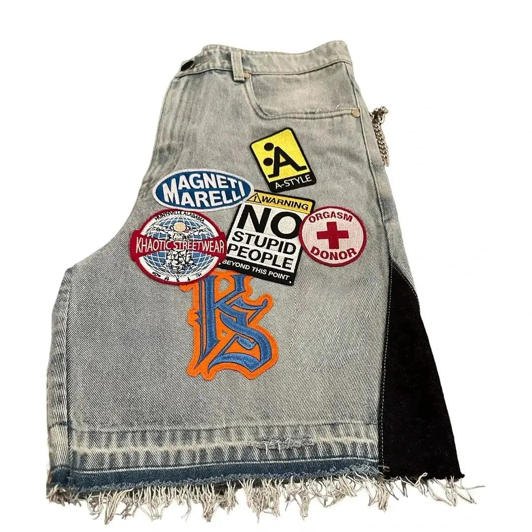 Light blue denim shorts with retro patchwork and frayed hem, featuring Magneti Marelli patch and graphic patches