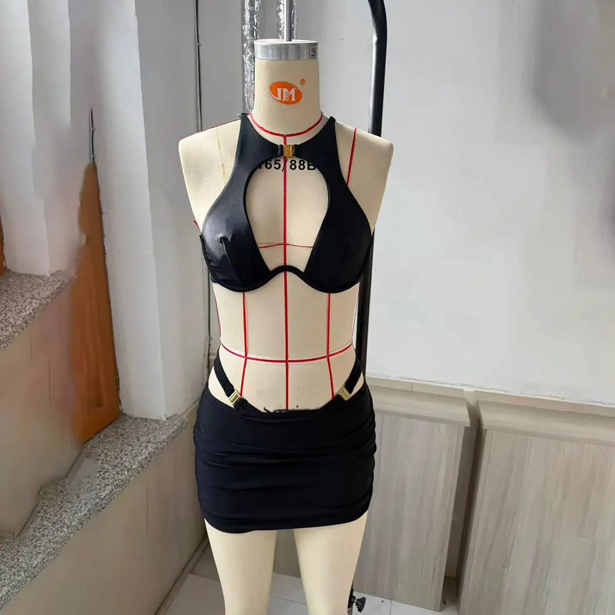 3-piece Simples Market black bikini set with push-up top and mini skirt on a dress form