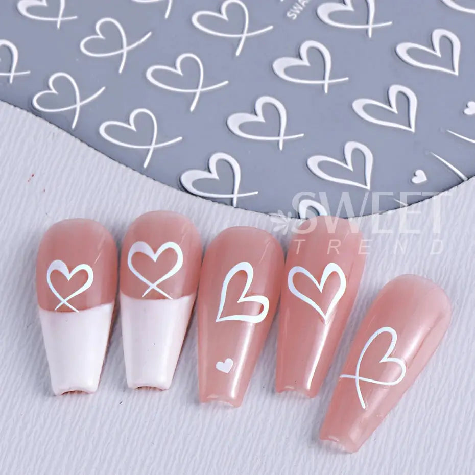 Valentine's Day nail art stickers with white heart and line designs on pink nails, 3D adhesive decals for DIY manicure