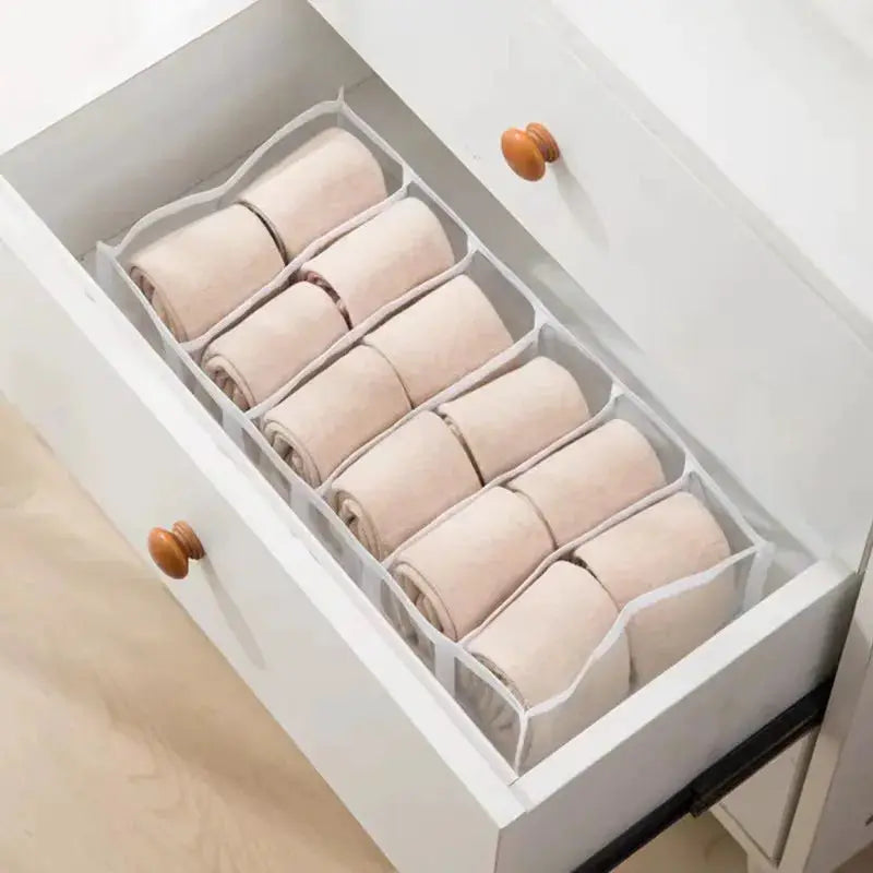 Closet organizer for underwear and socks in a white drawer with fabric dividers