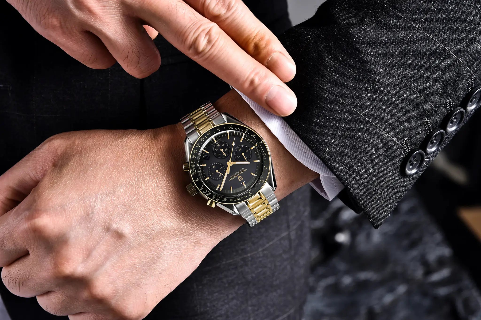 PAGANI DESIGN 500 Speedometer chronograph watch on a man's wrist; two-tone stainless steel bracelet, black dial.