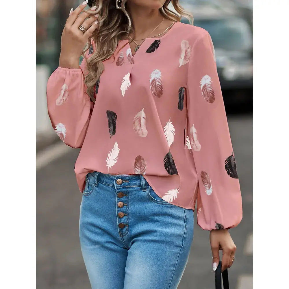 Pink feather-print chiffon blouse with long puff sleeves for women, shown with blue jeans.