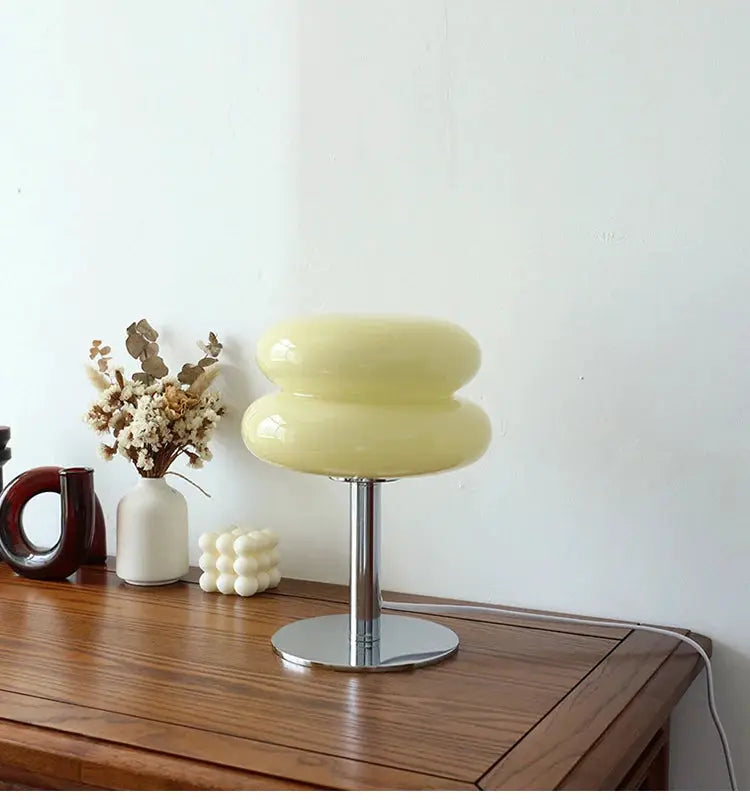Macaron glass table lamp with cream-yellow stacked shades on chrome pedestal.