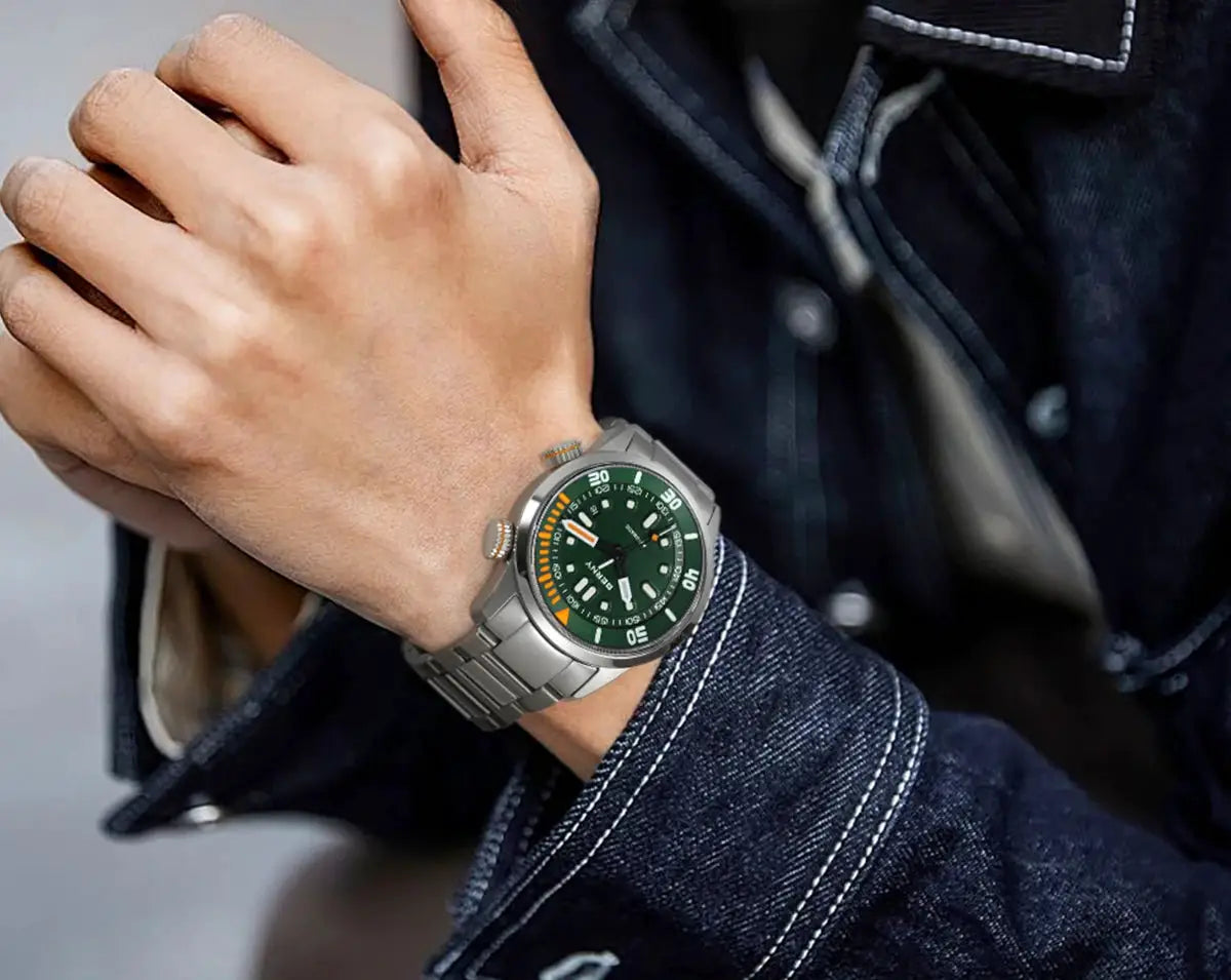 BERNY automatic dive watch with green dial and stainless steel bracelet on a man's wrist