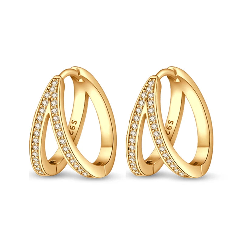 Gold-tone hoop earrings with crystal pavé along the front curve; 2 pairs shown
