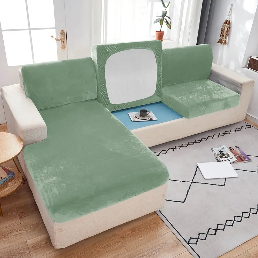 Plush sofa slipcover with anti-slip elastic edges in green on beige sectional sofa.