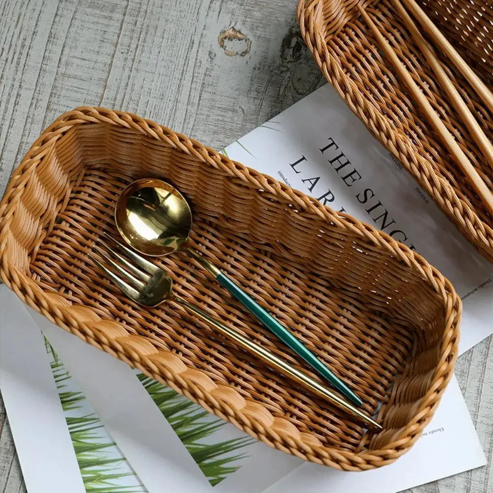 Imitation rattan storage basket tray in light brown with gold-toned spoon and green-handled fork inside