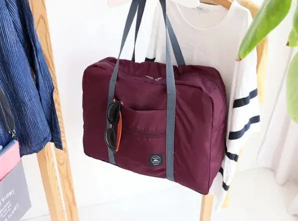 1pc large capacity travel bag by Simples Market for unisex use in burgundy with gray handles and front pocket