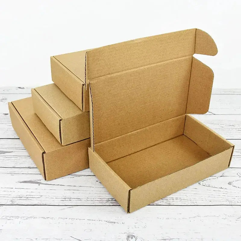 Gift box set, five-piece brown kraft paper with lids on a white wooden surface.
