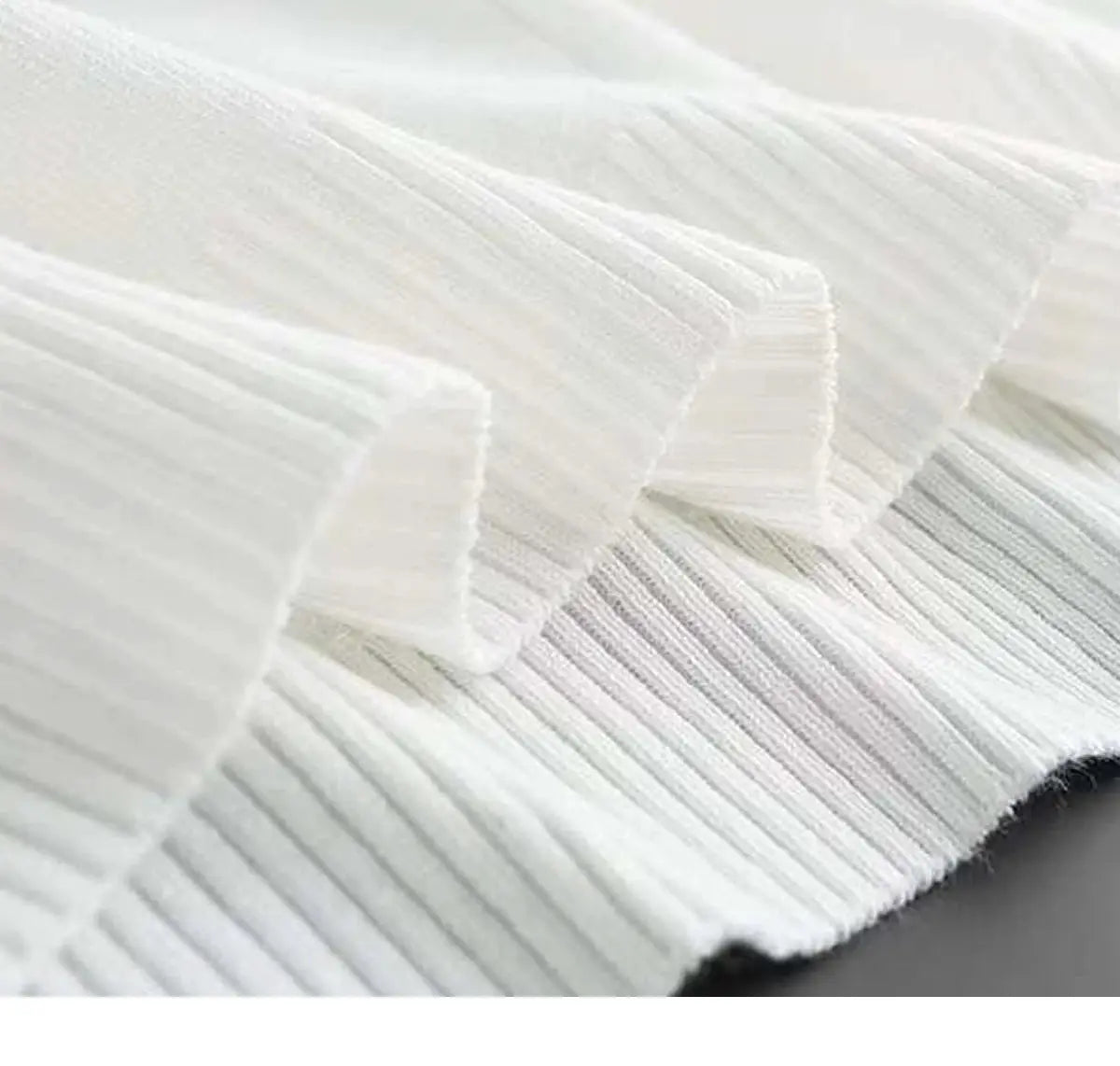Men's white knit polo shirt close-up; ribbed fabric and collar edge