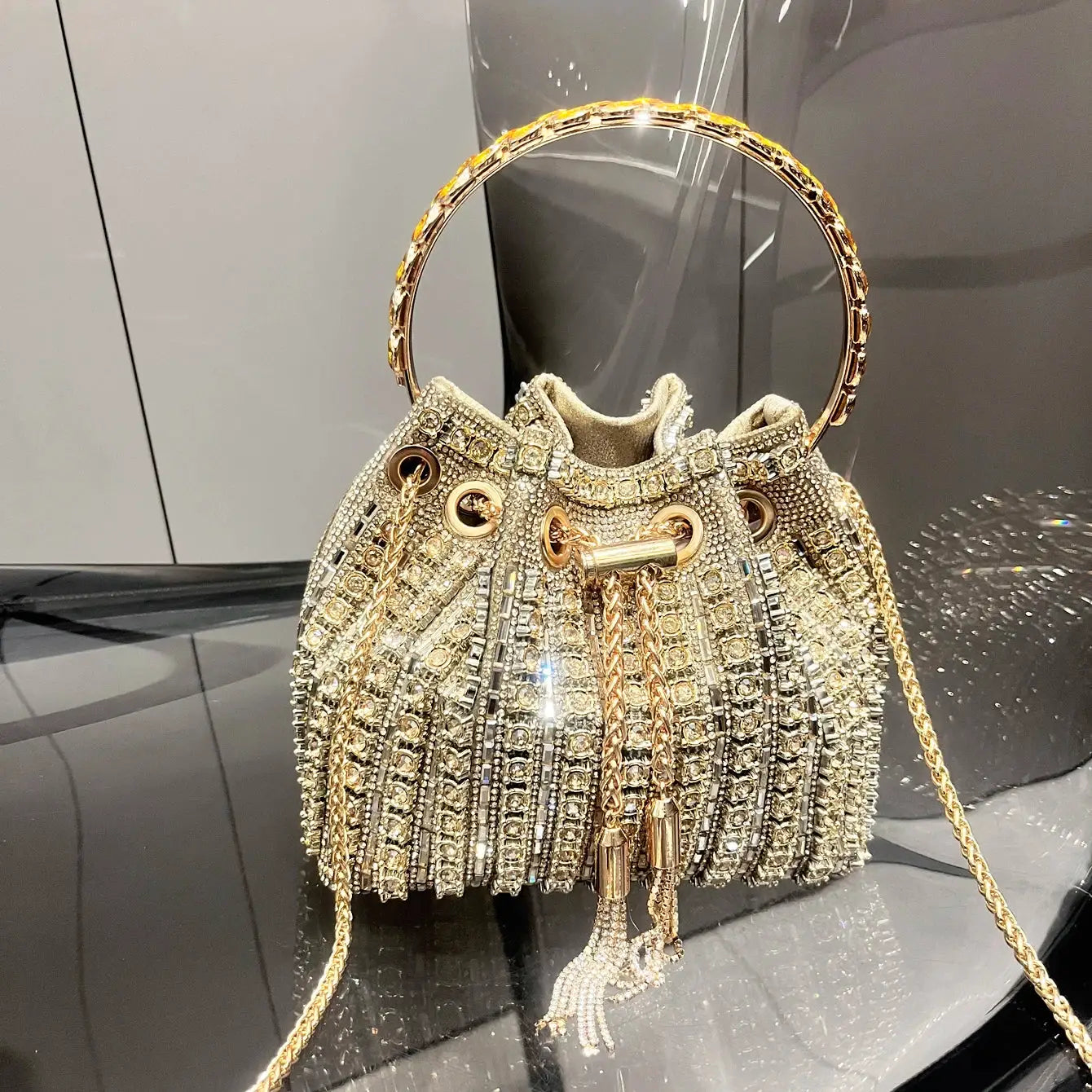 Bucket bag crystal rhinestone purse by Simples Market with gold-tone circular handle and fringe tassels