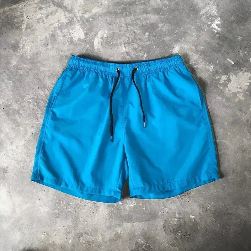 Men's blue board shorts with black drawstring and elastic waistband
