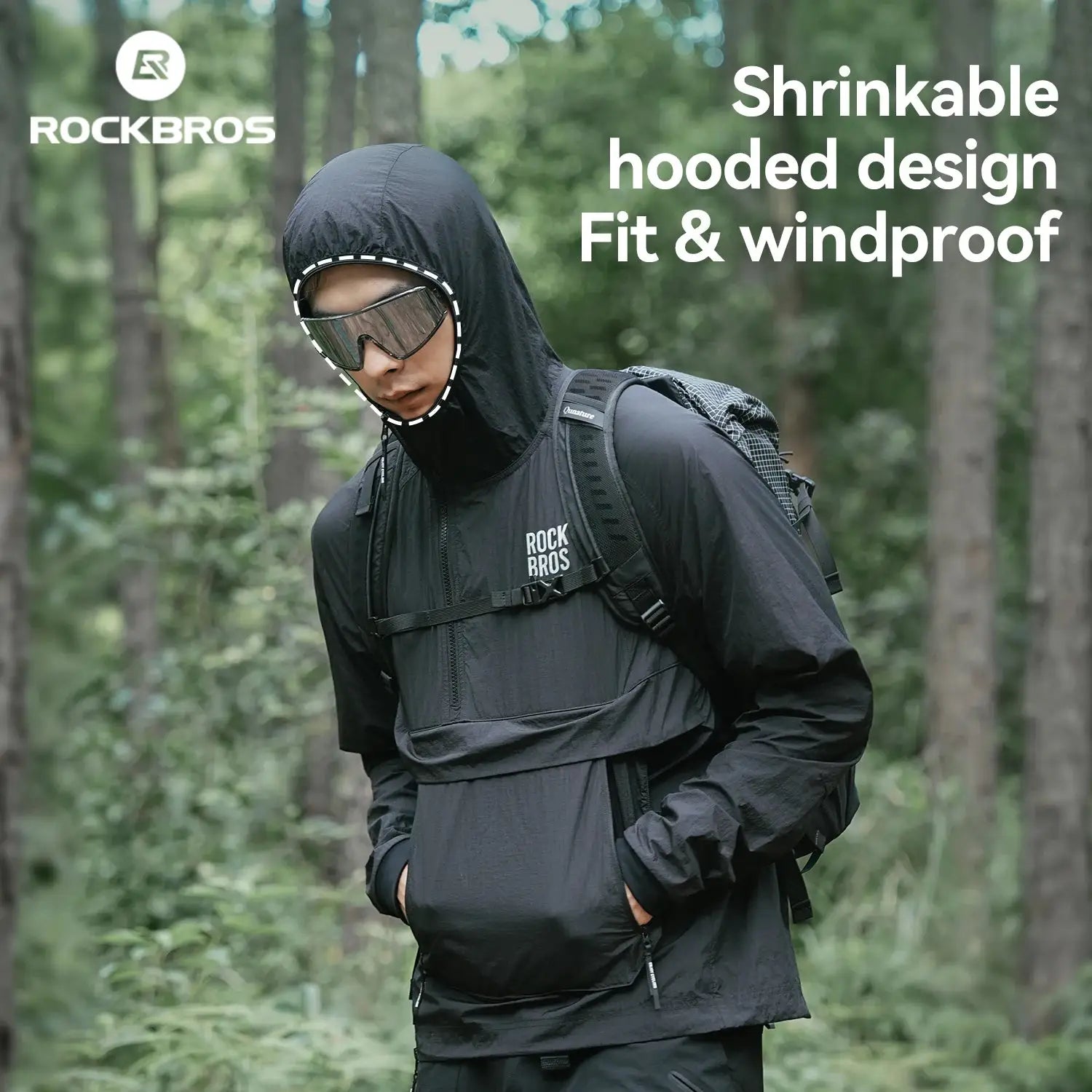 ROCKBROS black cycling waterproof jacket with hood, windproof, breathable, worn with backpack in a forest.