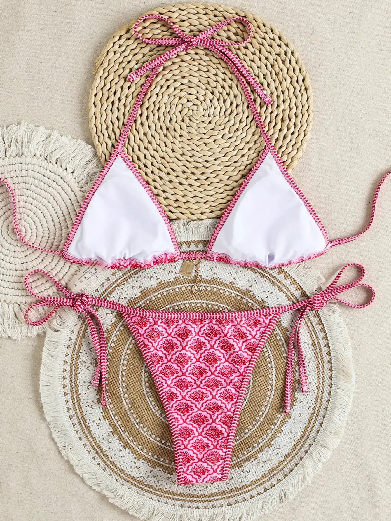 Triangle bikini set with white top, pink trim, and pink floral Brazilian bottoms