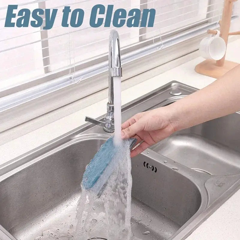 Lint remover brush with blue microfiber bristles being rinsed under running water at a kitchen sink