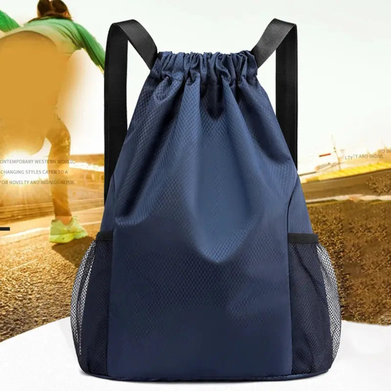 Navy blue drawstring backpack with black straps and side mesh pockets, unisex large-capacity travel bag.