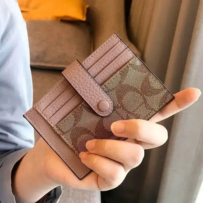 Monogram card holder in pink-brown with strap snap closure and multiple card slots