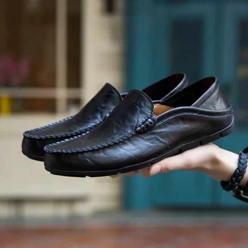Pair of men's black genuine leather loafers; slip-on moccasin-style casual shoes