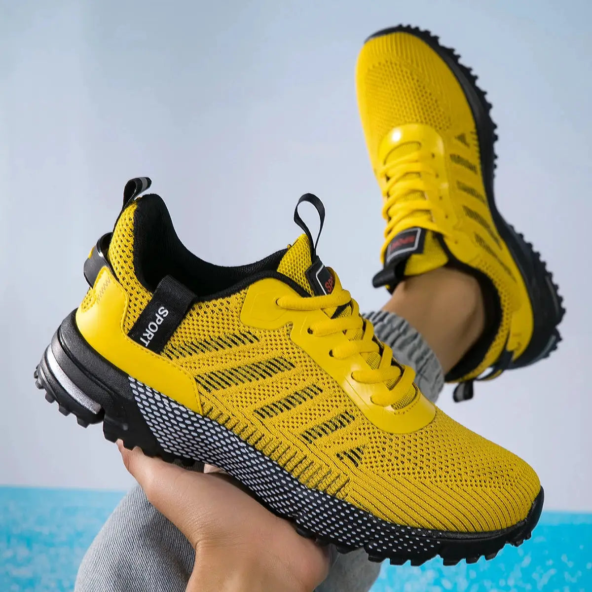 Men's yellow lace-up running shoes with breathable mesh, lightweight, non-slip outsole.