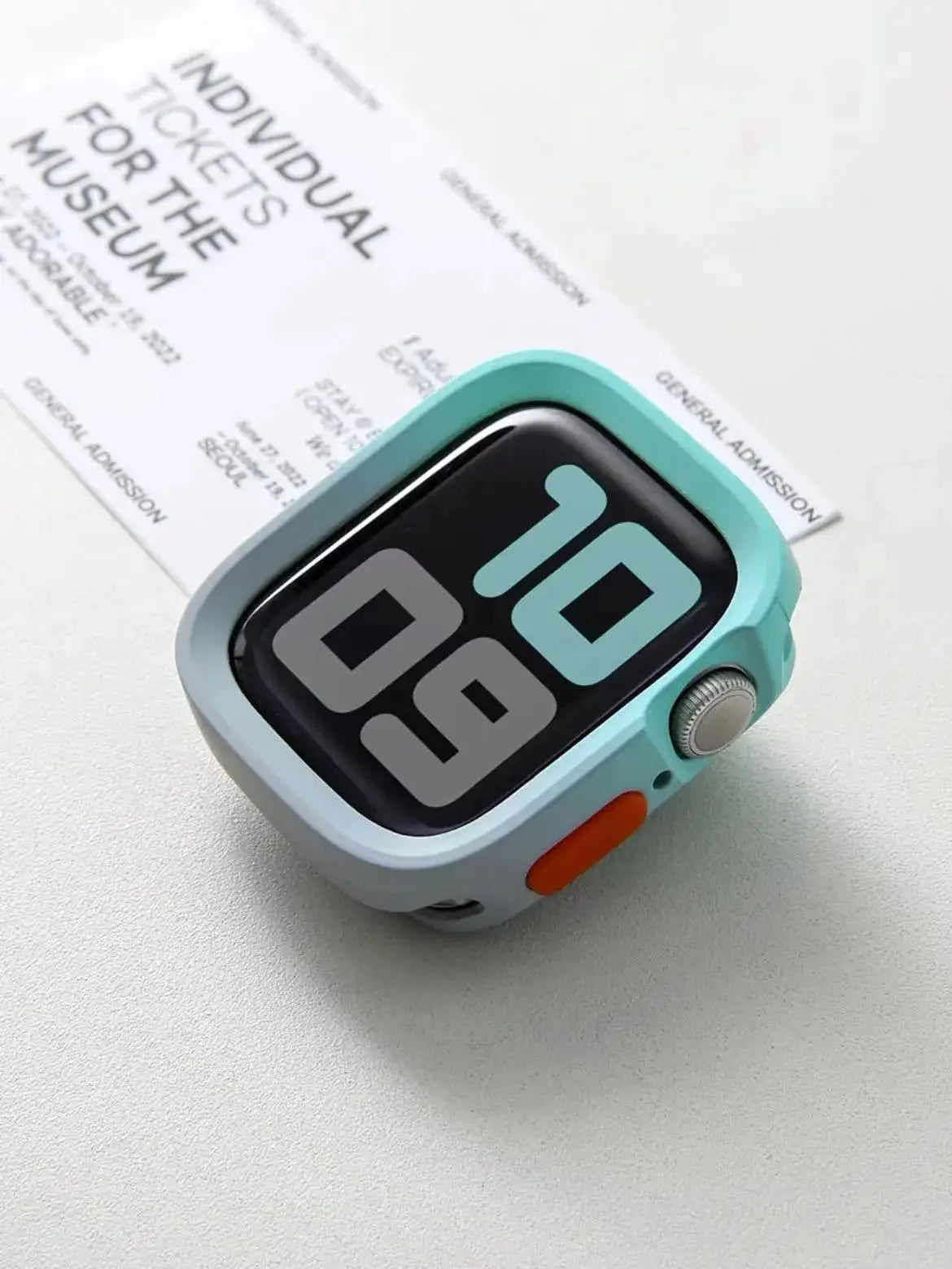 Simples Market bumper silicone case for Apple Watch; mint teal with orange side button, anti-drop protection.