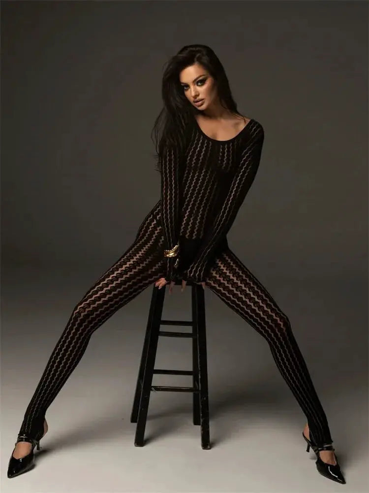 Tossy see-through black mesh jumpsuit with hollow-out pattern, worn by model