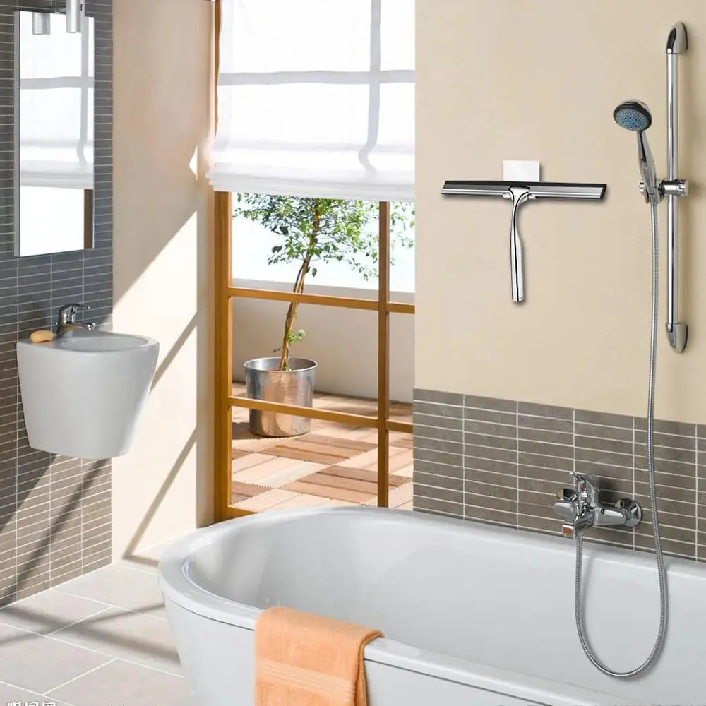 Shower squeegee with silicone holder mounted on bathroom wall; chrome finish