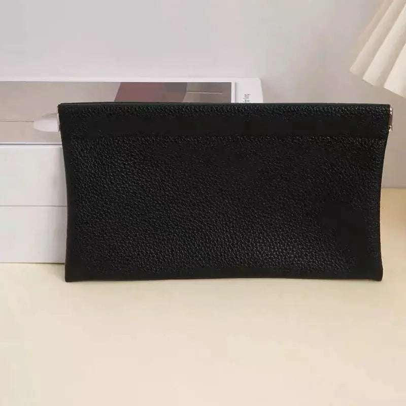 Self-closing artificial leather long wallet in black with pebbled texture.