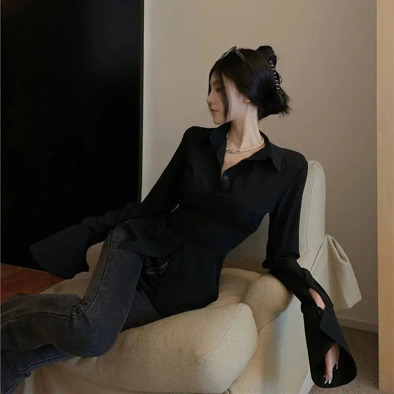 Gidyq black bandage blouse for women with long bell sleeves.