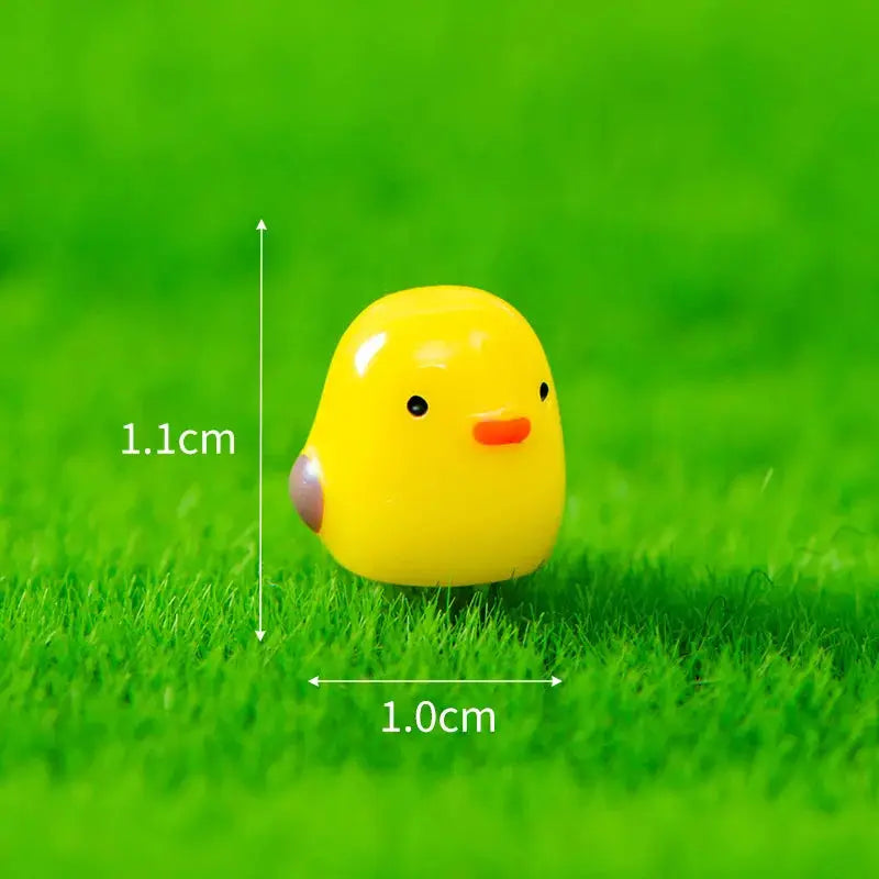 Yellow chick car interior ornament, 1.1 cm tall by 1.0 cm wide.
