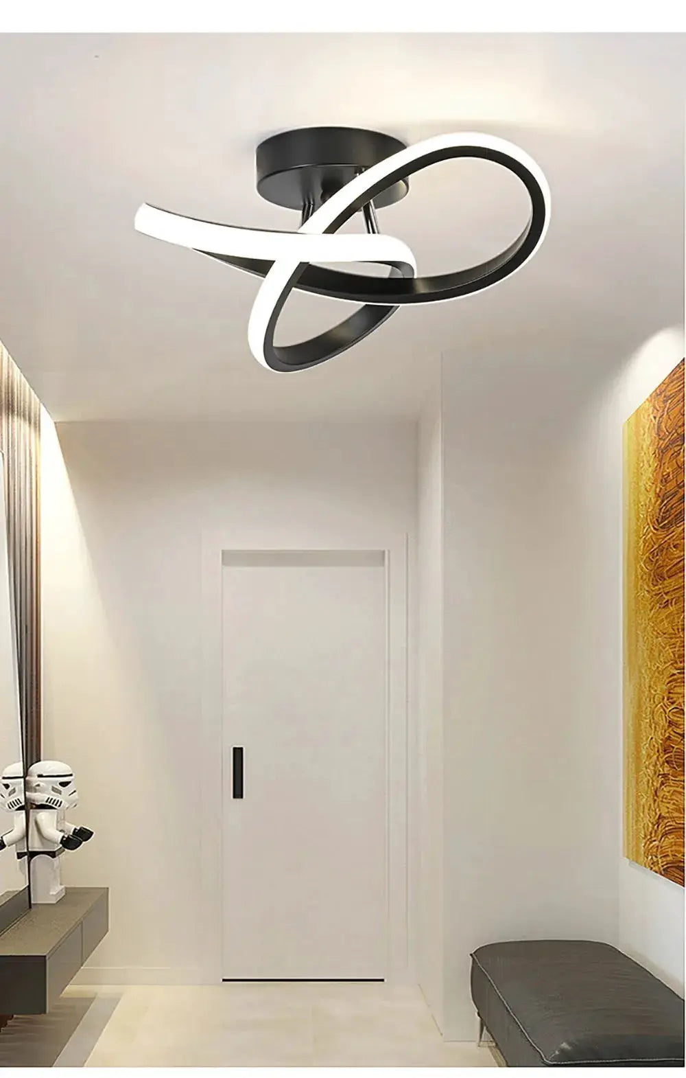 Modern LED surface-mounted ceiling light with interlocking loop design in black and white, mounted in a bright hallway.