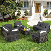 Outdoor sofa cushions on black wicker patio furniture with gray cushions