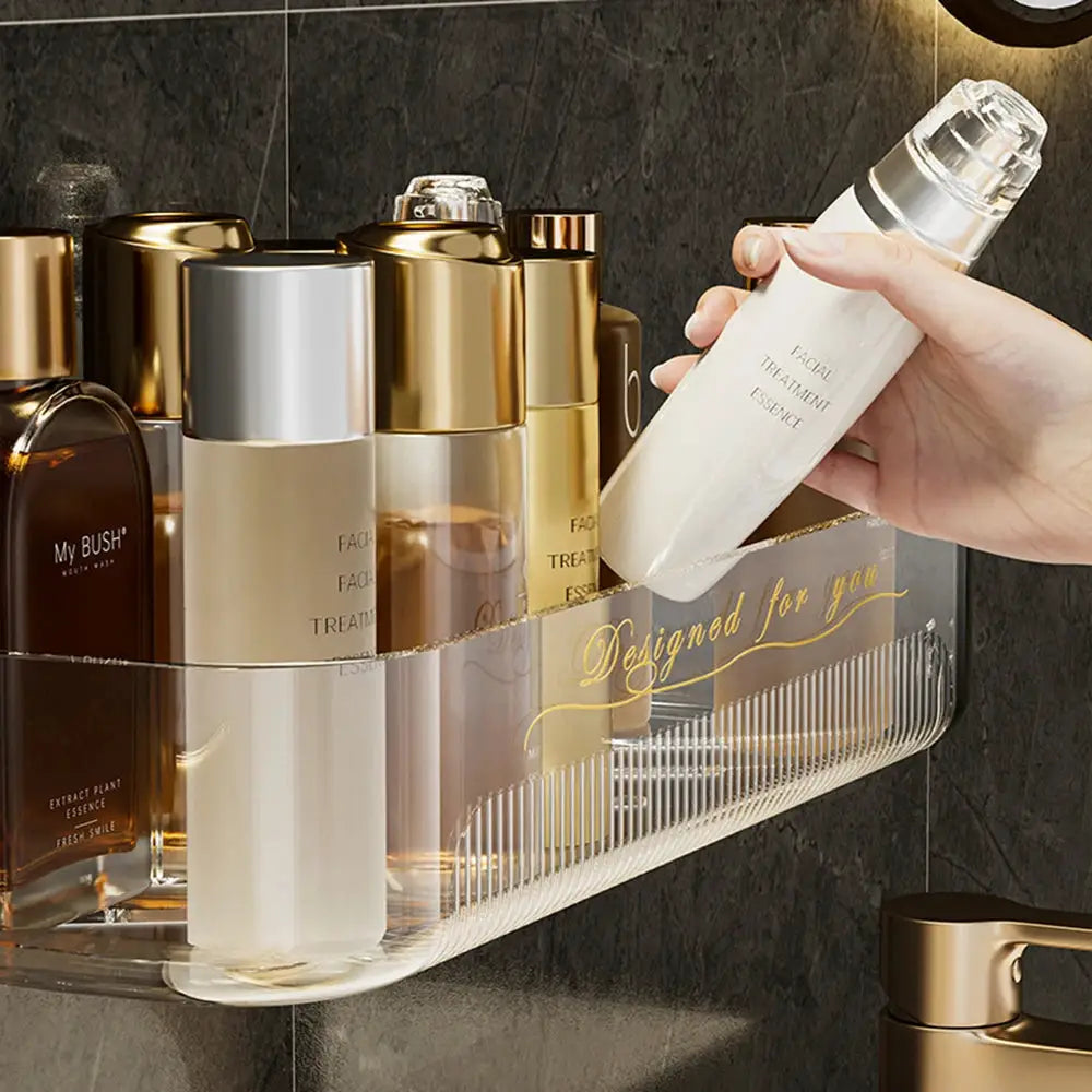 Light luxury acrylic bathroom storage rack holding multiple cosmetic bottles; clear with gold accents