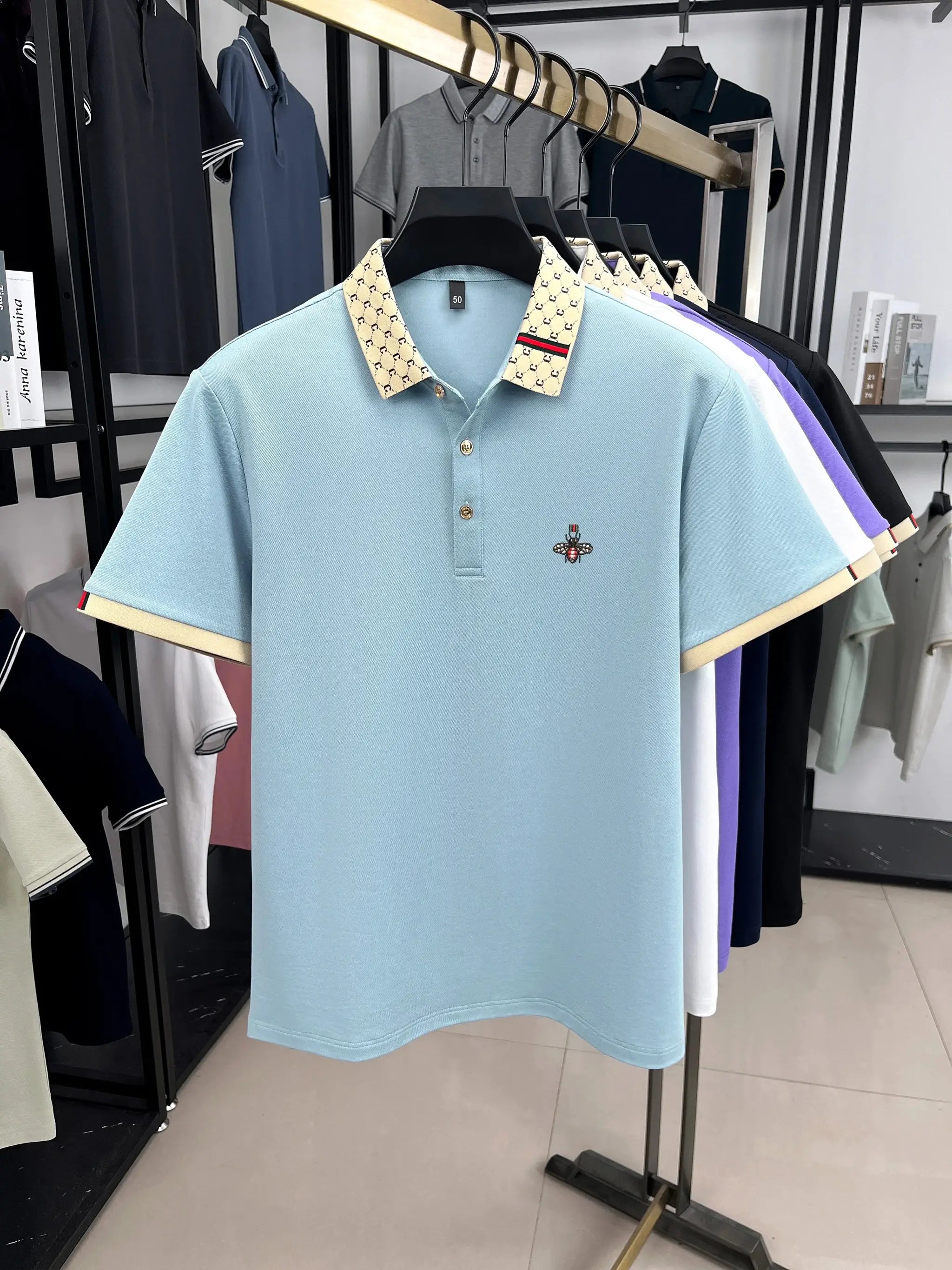 Polo shirt in light blue with beige patterned collar and bee embroidery