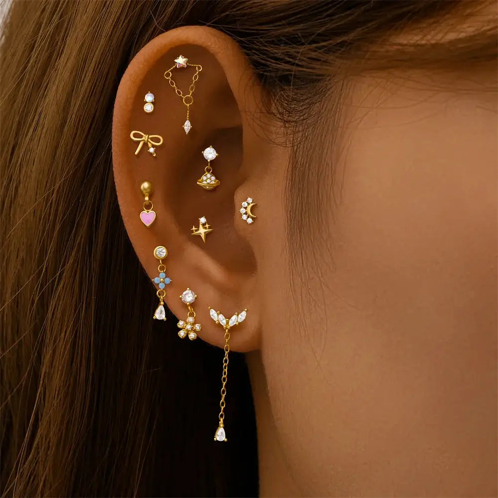 Gold-tone ear jewelry set with multiple zircon-stone studs and dangling chains