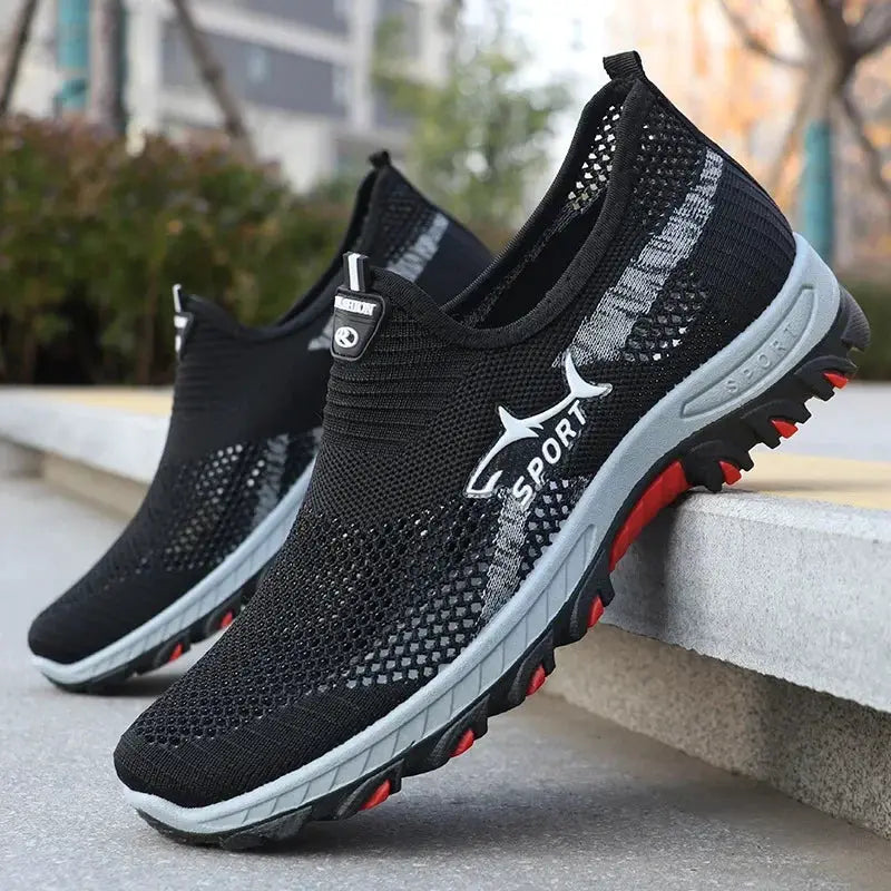 Pair of men's sport mesh sneakers, black breathable knit upper, gray midsole with red outsole accents by Simples Market
