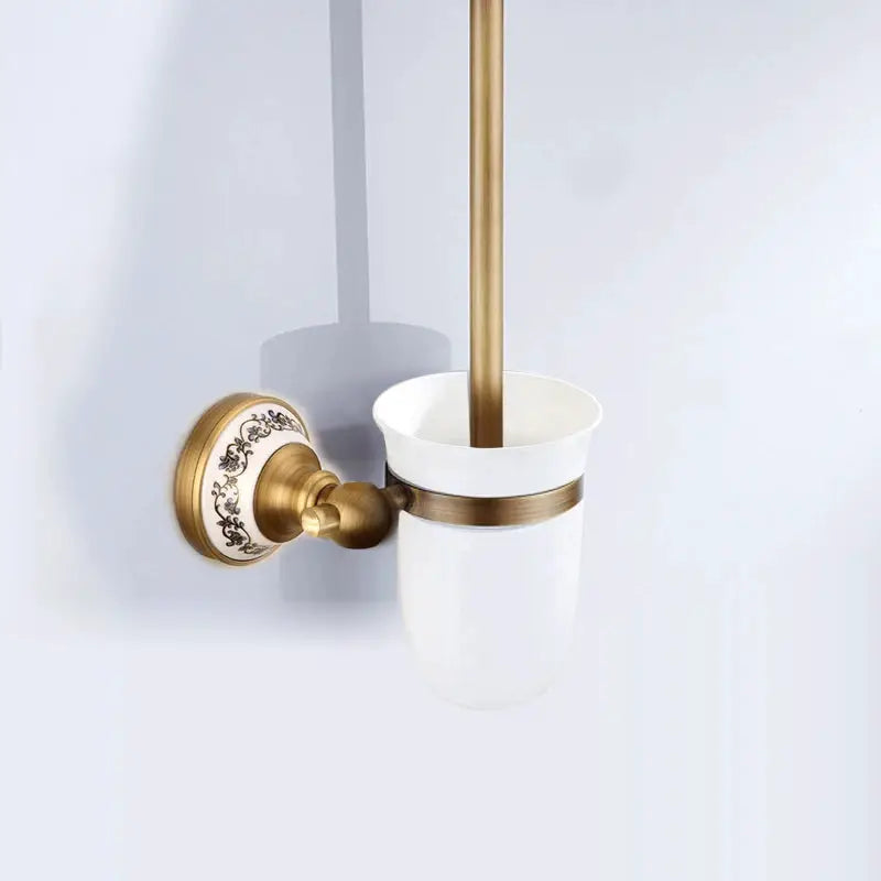 Antique brushed brass bathroom tumbler holder set with white porcelain cup and floral wall mount
