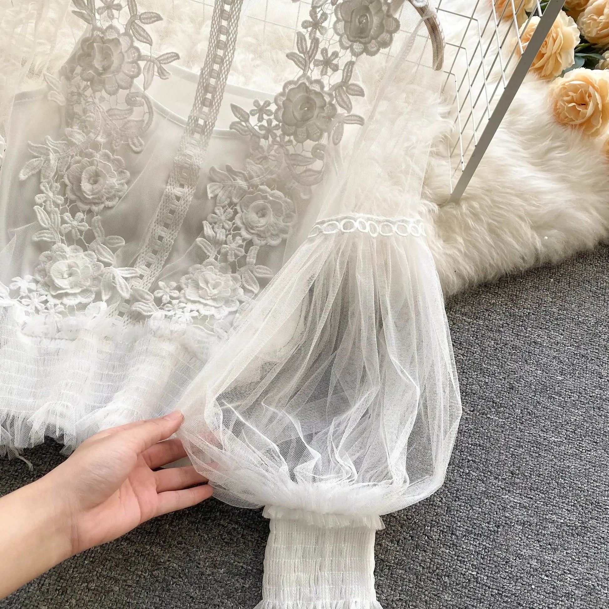 Lace puff long-sleeve blouse in white with floral embroidery and sheer layers.