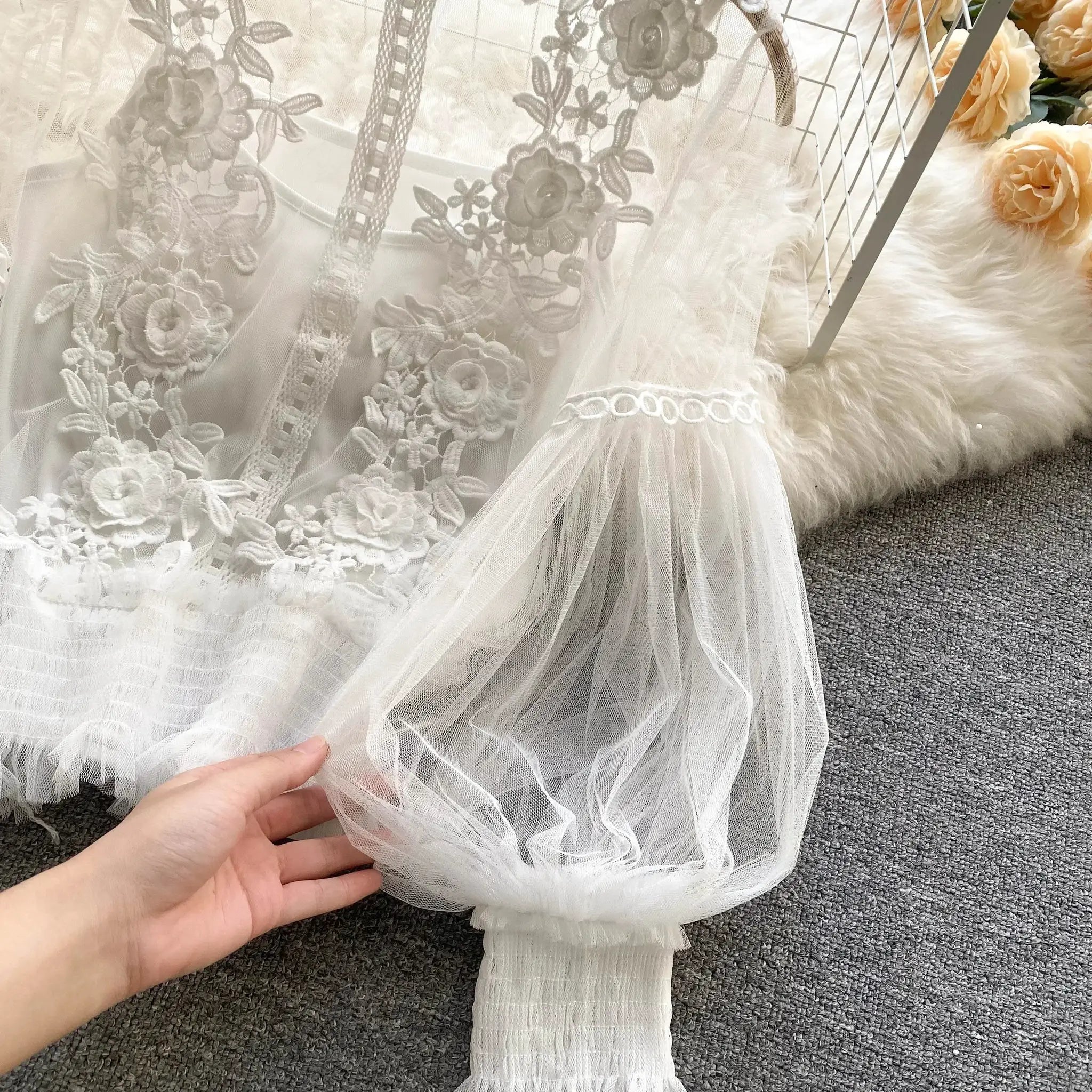 Lace puff long-sleeve blouse in white with floral embroidery and sheer layers.