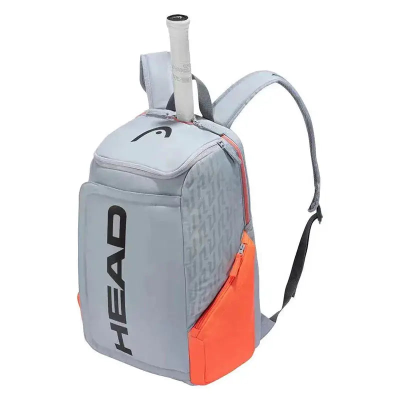 HEAD Original Radical Tennis Backpack, grey with orange side pocket and HEAD logo.